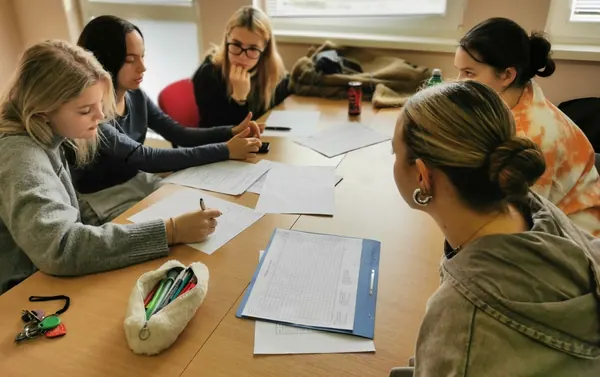 Students working on business documents