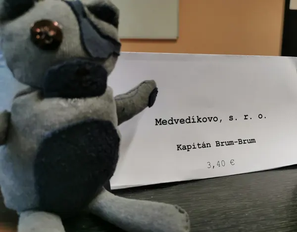 A handmade teddy bear with a price card from a student practice company