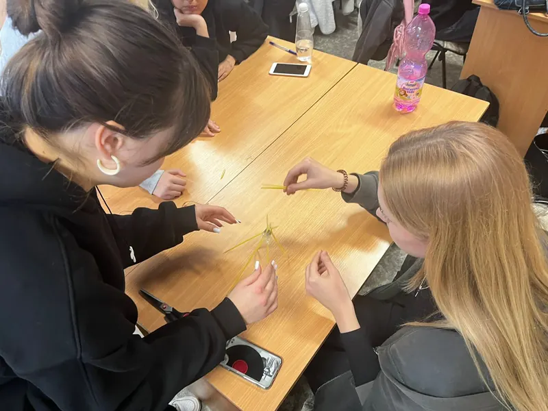 Students building a spaghetti tower in a team challenge