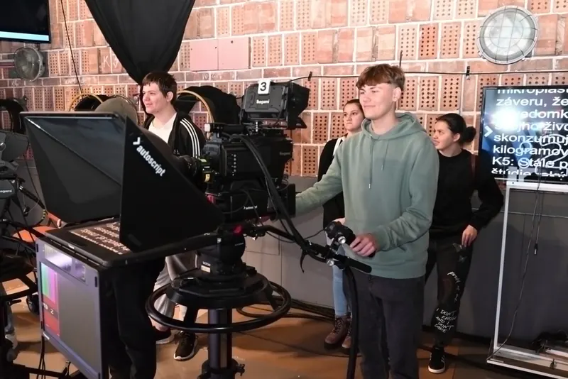Students operating cameras in a TV studio